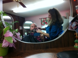 Halfway through the task, Theresa Constantine works on my thick beard.